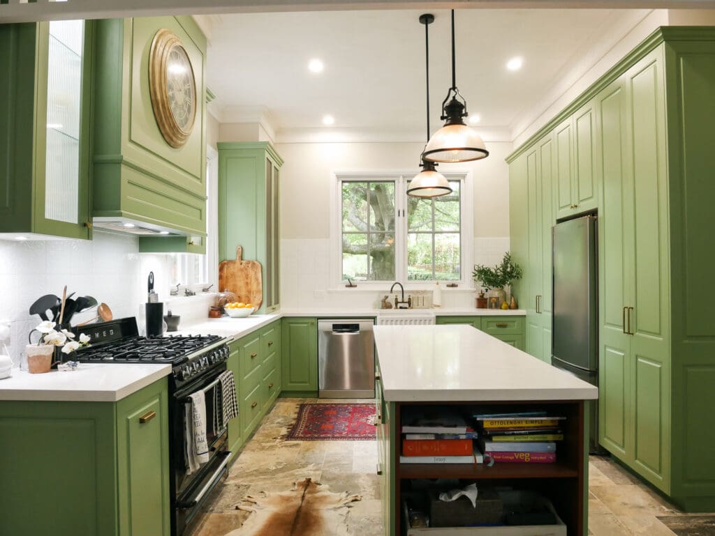 Southern Highlands kitchen with a Smartstone Davinci Blanco island, fluted glass pendants above, and earthy stone veining extending into Southern Cross Ceramic tiles, creating a seamless and grounded design.