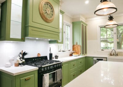 Smeg freestanding oven and dishwasher paired with a Westinghouse concealed range hood, creating a sleek and functional kitchen design.