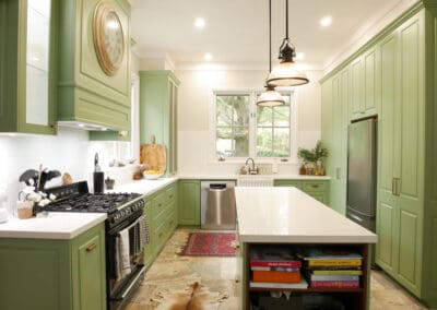 Sophisticated Southern Highlands kitchen with a Smartstone Davinci Blanco island, fluted glass pendants above, and earthy stone veining extending into Southern Cross Ceramic tiles, creating a seamless and grounded design.