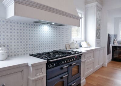 Stunning cross-hatched upper cabinetry enhances the lighting, adding an extra layer of elegance to the space.