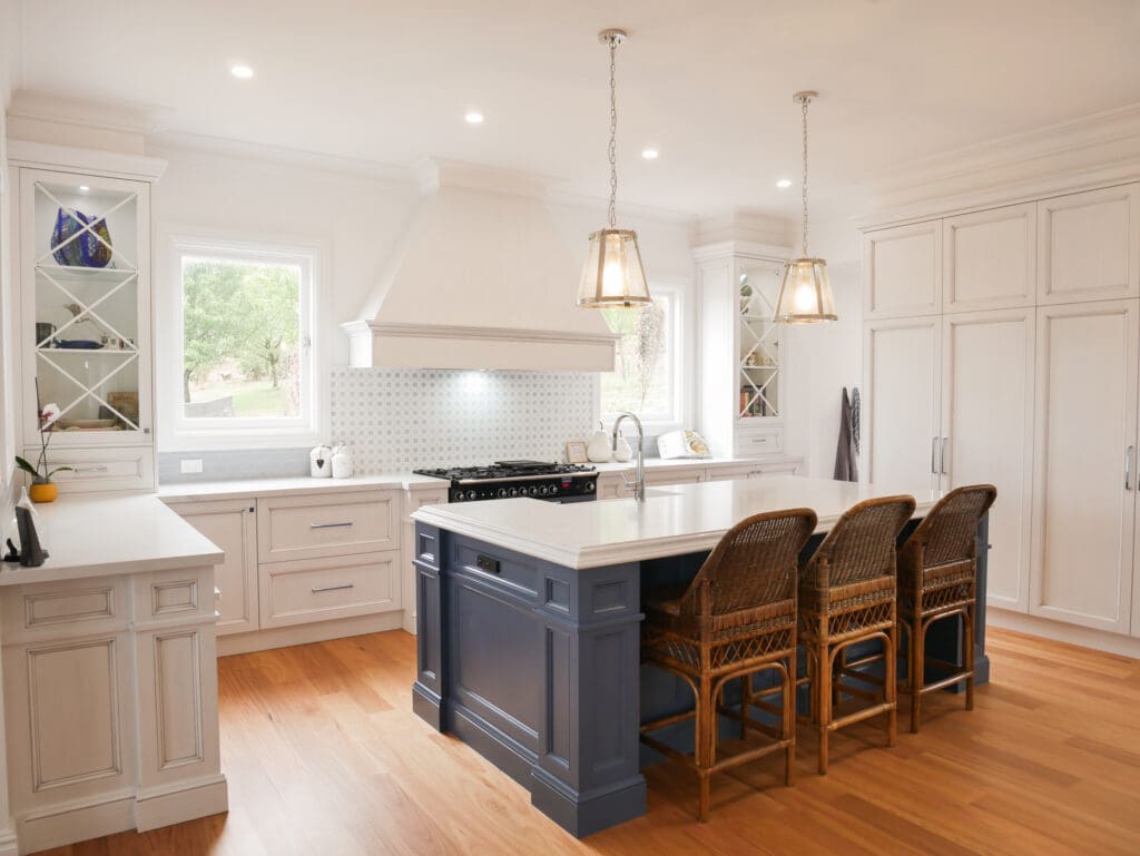 In the two-toned kitchen, the clients selected a Schweigen rangehood, with the integrated dishwasher and fridge blending seamlessly into the island and wall cabinetry.