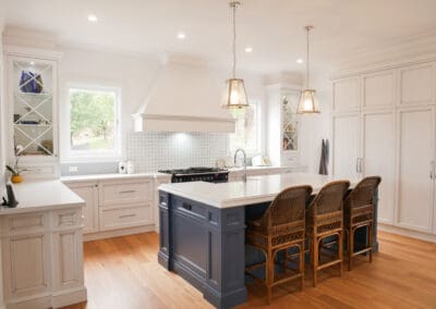 In the two-toned kitchen, the clients selected a Schweigen rangehood, with the integrated dishwasher and fridge blending seamlessly into the island and wall cabinetry.