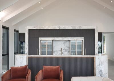 Bespoke, high-end cabana and entertainment wing designed by Studio Jenka, featuring a Ravenswood Navurban bar kitchen with deep anthracite internals, obsidian hinges, electronic bin systems, automated lighting, and anthracite Advantech YOU drawer systems from Hettich.