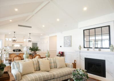 A fireplace featuring a beautiful mantle and base crafted from Precious White honed marble, bringing luxurious warmth to the room.