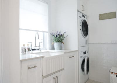 Laundry featuring a fluted Turner Hastings Novi butlers sink and satin nickel Bondi handles on the cabinetry, blending modern and traditional design elements.
