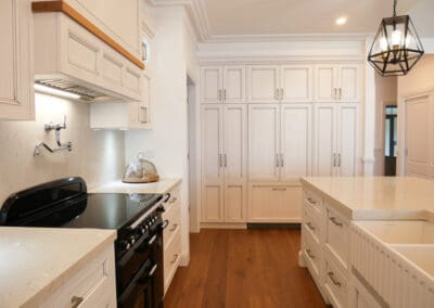 Dulux Lexicon quarter strength paired with Dulux Domino creates a striking contrast, while the traditional profile throughout enhances the detailed design.