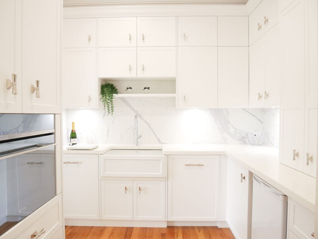 Kitchen with a matching Smeg oven and cooktop, and a Smeg wall oven in the butler's pantry. The pantry also includes a Smeg microwave, integrated dishwasher, beverage fridge, and 1901 butler's sink, designed for seamless entertaining.
