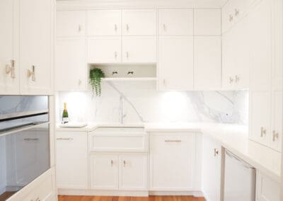 Kitchen with a matching Smeg oven and cooktop, and a Smeg wall oven in the butler's pantry. The pantry also includes a Smeg microwave, integrated dishwasher, beverage fridge, and 1901 butler's sink, designed for seamless entertaining.