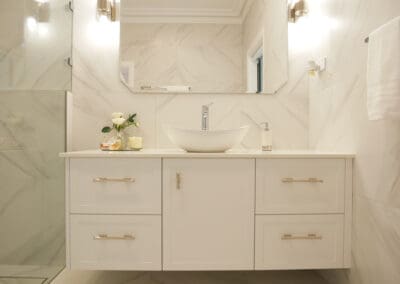 Ensuite and powder room vanities featuring top mount San Ceramica sinks with modern single taps, set atop 20mm Quantum Quartz Alpine White surfaces, matching the cabinetry throughout the house.