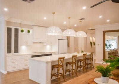 Elegant kitchen with natural timber tones, featuring Dulux Lexicon ¼ strength matte cabinetry and YDL Stone 'Vene Rose' benchtops and splashbacks, highlighting taupe veining that complements the warm timber.
