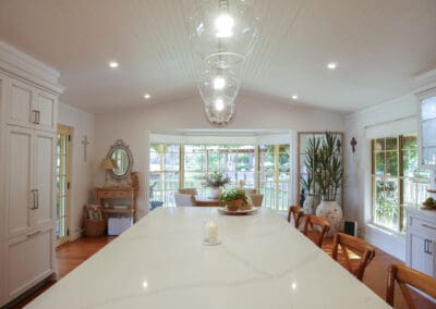 The pure white base of the kitchen stone benchtop, accented with free-flowing light grey veins, complements the hand-painted cabinetry and Mt Eden color scheme perfectly.