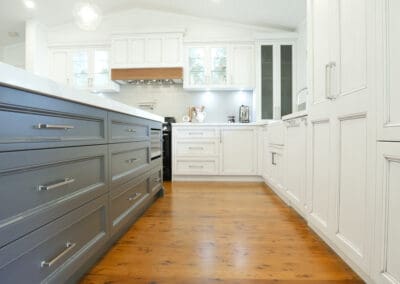 Classic two-toned country hand-painted cabinetry designed with decorative Chifley style door frames, beautifully complementing the country residence's aesthetic.
