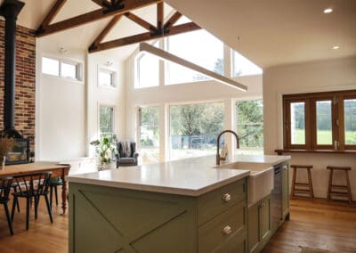 Hamptons-style kitchen on a farm in Robertson's Southern Highlands, featuring natural light from large windows and a charming country-style feel.