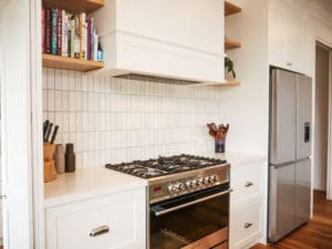 Fisher & Paykel freestanding oven paired with a Fisher & Paykel integrated rangehood in the kitchen.