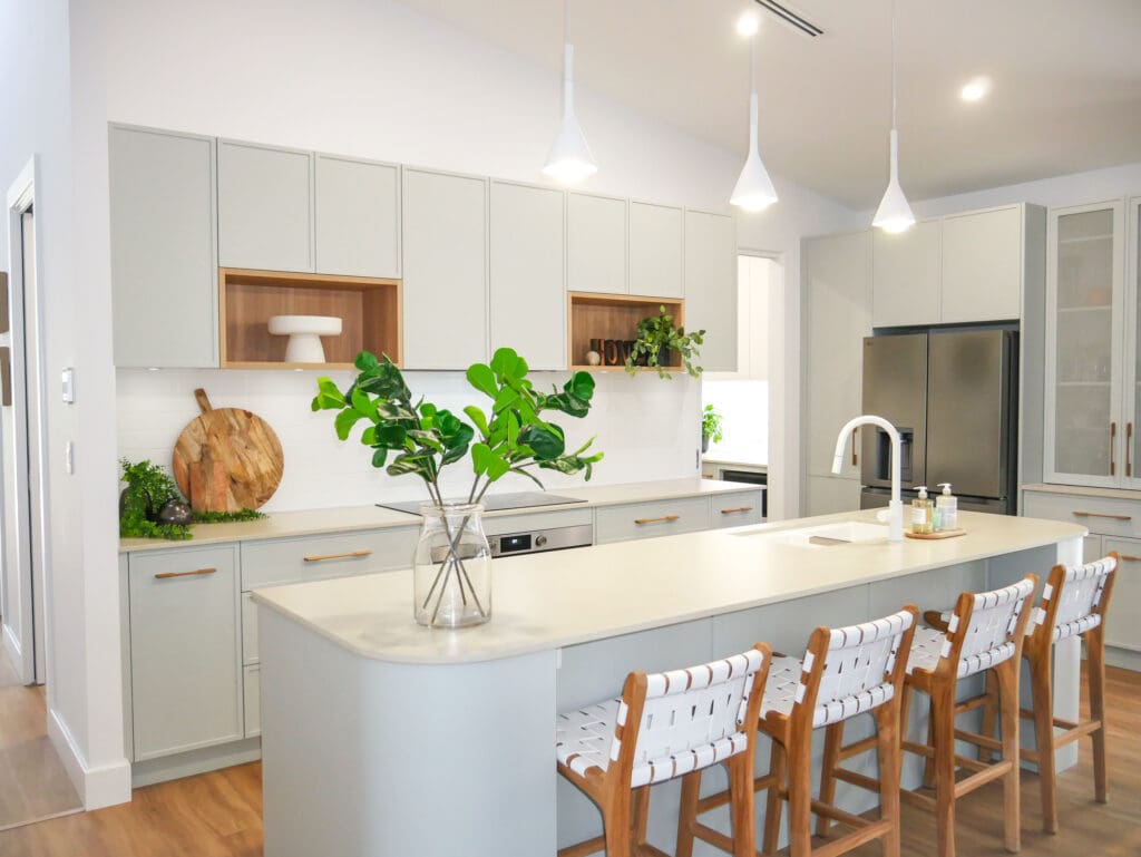 Modern open-plan kitchen with sleek cabinetry and island seating, showcasing a stylish renovation that reflects smart kitchen renovation costs.