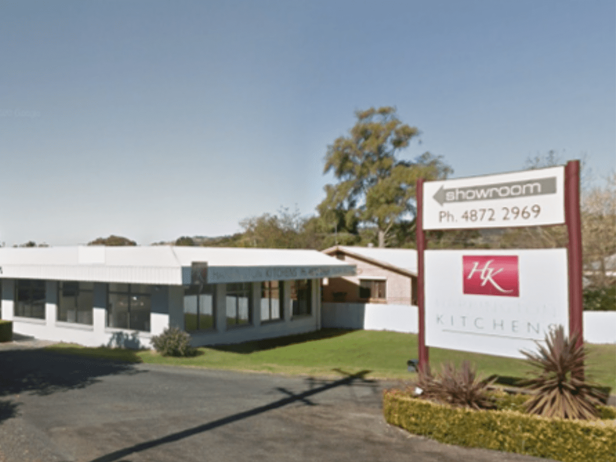Exterior of Harrington Kitchens Mittagong showroom with clear signage, large windows, and welcoming entrance.