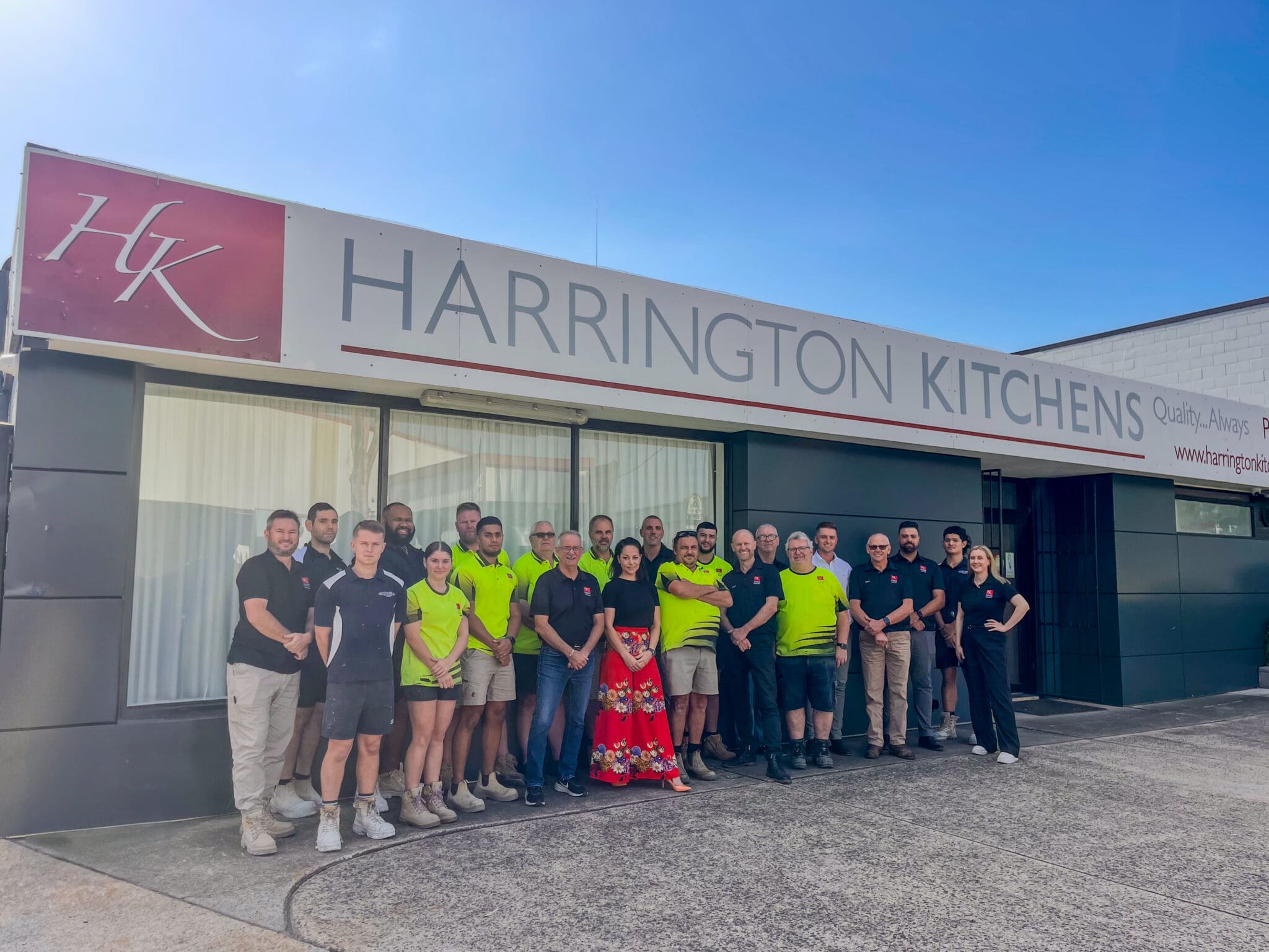 Outside Team Photos-09 Harrington Kitchens team standing together in front of the Harrington Kitchens manufacturing facility in Narellan, smiling and dressed in work uniforms, showcasing the team spirit and professional environment.