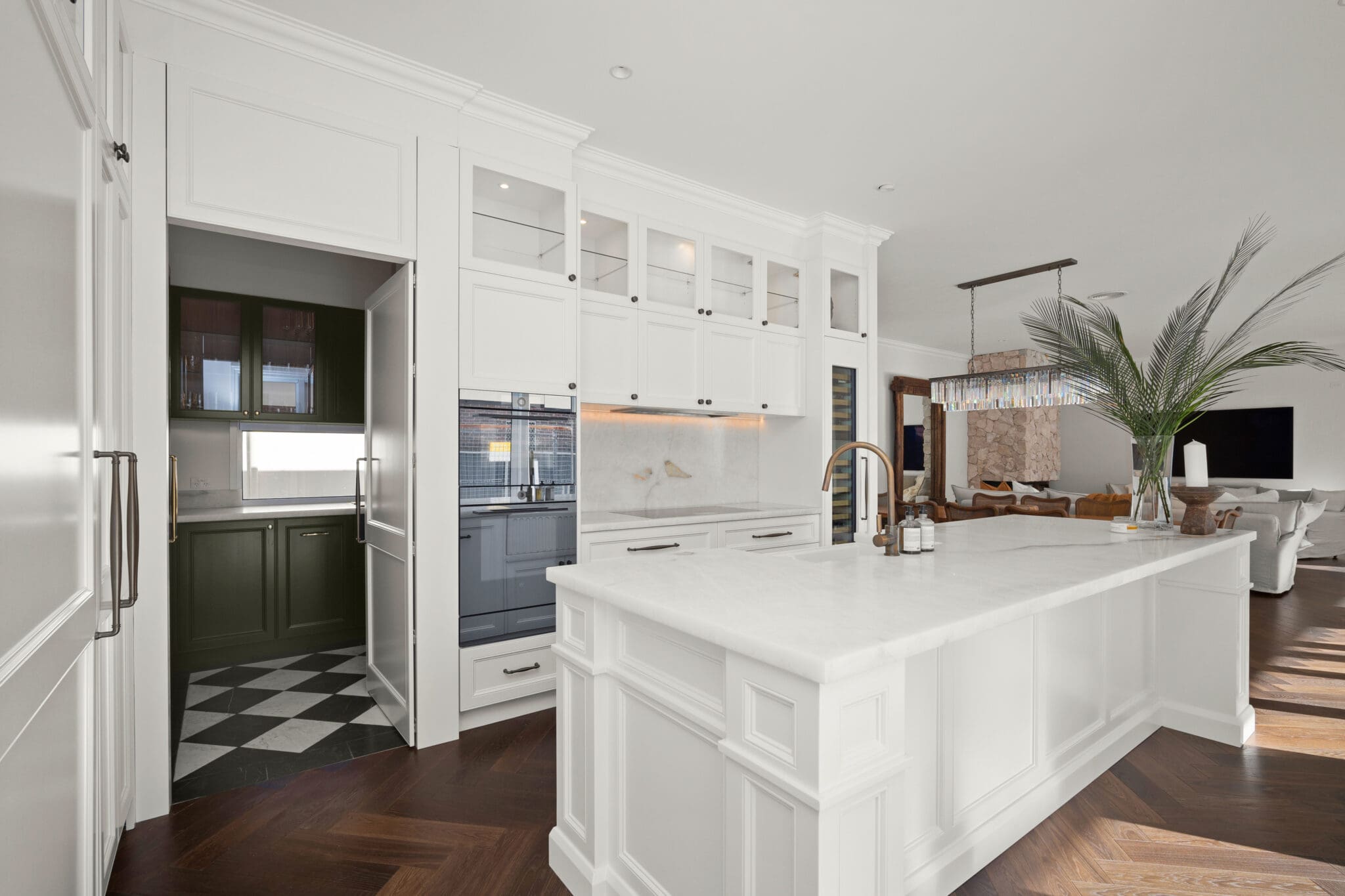 custom kitchen cabinets in white provincial style with upper glass cabinetry. Bronze, tap and handles.