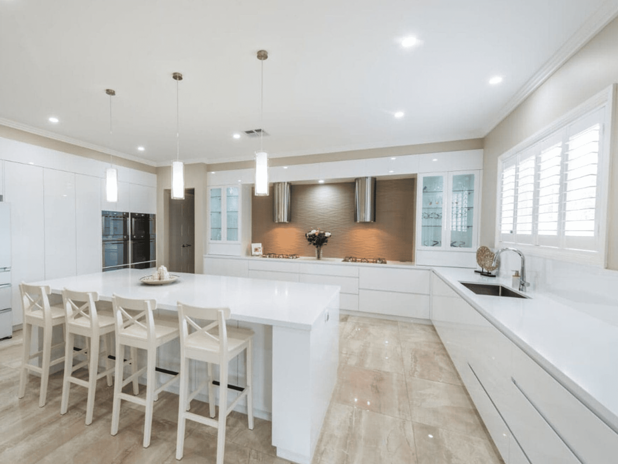 Sleek white-on-white modern kitchen in Minto with high-gloss finishes and seamless cabinetry by Harrington Kitchens.