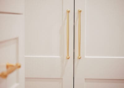 Champagne gold Esperance cabinet handles on white shaker cabinets.