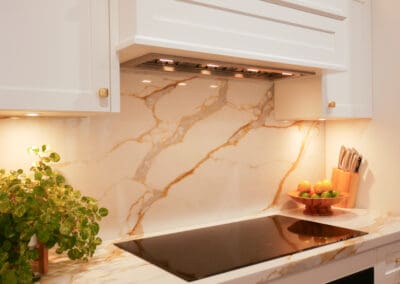 Custom rangehood with a splashback featuring YDL Ella Oro stone.