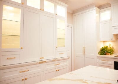 Integrated Appliance Cupboard Framed by Reeded Glass Cabinets