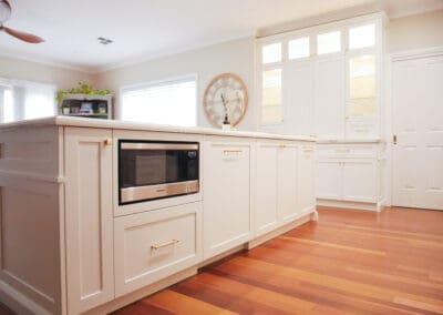 Modern kitchen island featuring an integrated microwave, sleek cabinetry, and a functional countertop for cooking and entertaining.