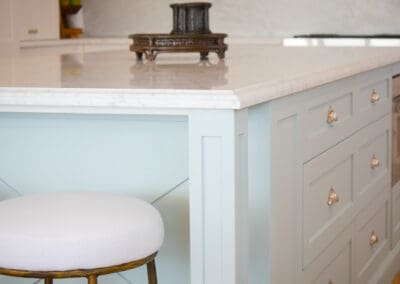 Crafted kitchen island with pillar end detail and lamb’s tongue marble edge profile.