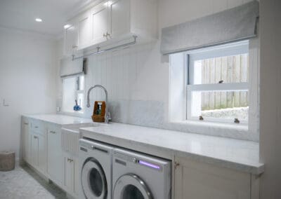 Laundry room with white shaker cabinetry and Carrara marble benchtop