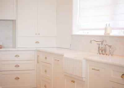 Turner Hastings Novi double-sided ribbed fireclay farmhouse sink in white shaker kitchen cabinetry.