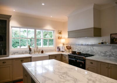 Neutral tone kitchen with hand-painted cabinetry, soft finishes, and classic design details.