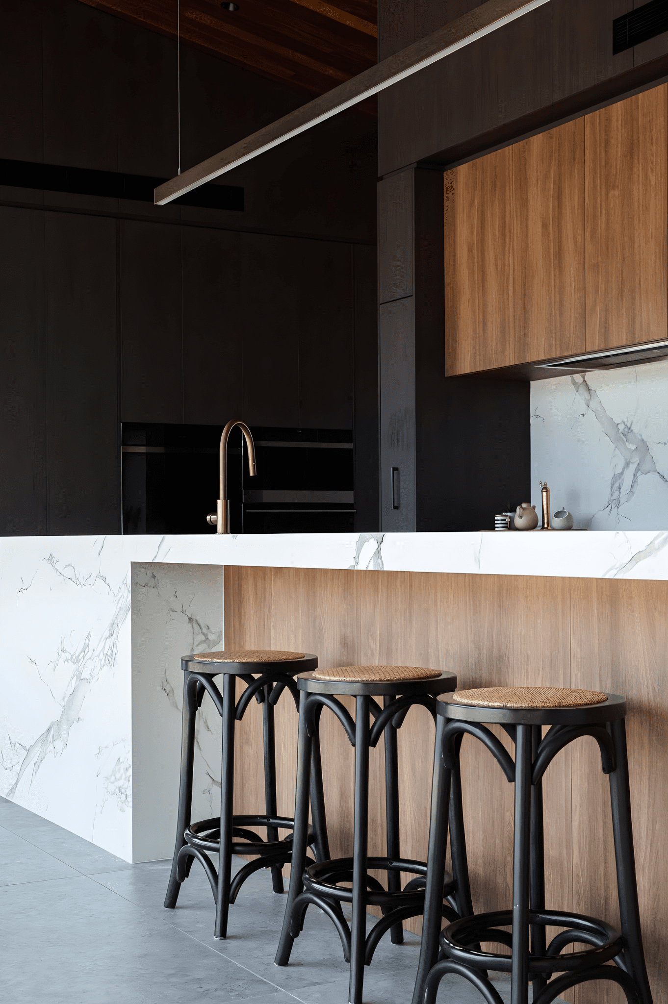 designer kitchen featuring timber panels and stone island