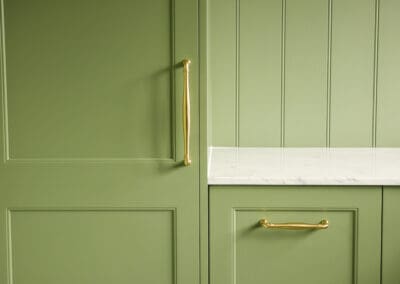 green laundry space with gold handles